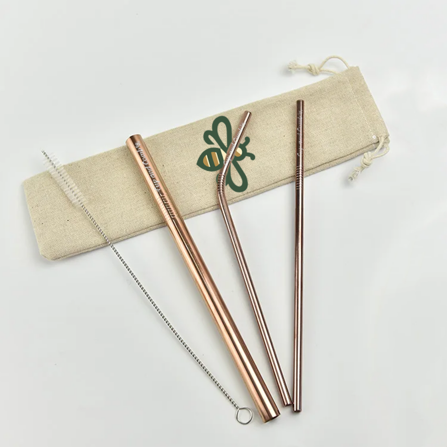 Top view of eco-friendly rose gold 3-piece metal straw set with cleaner and reusable bag, perfect for sustainable drinking